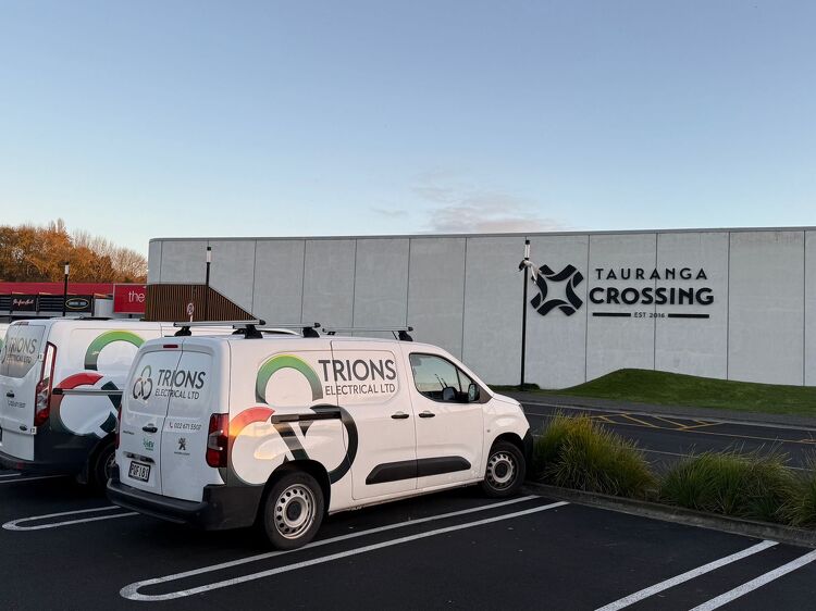 Fleet of Trions Electrical vans parked at Tauranga Crossing shopping centre.